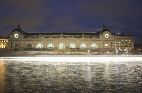 A sightseeing river boat passes in front of the Musee D'orsay