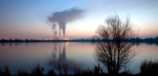 View across a lake towrds the sugar beet factory in Newark, UK.