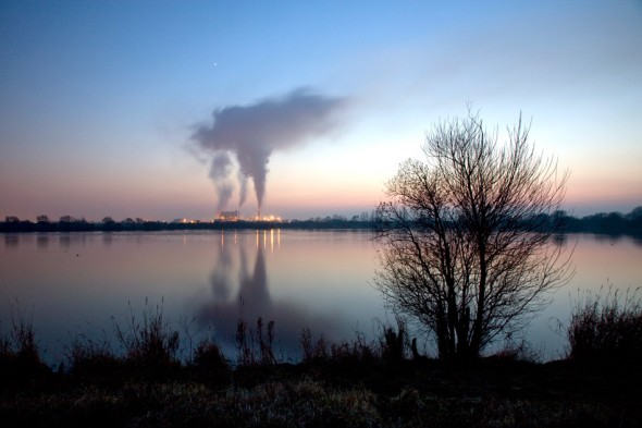 View across a lake towrds the sugar beet factory in Newark, UK.